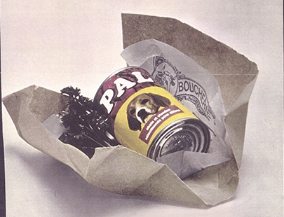 A can of PAL food for dogs, wrapped in paper.