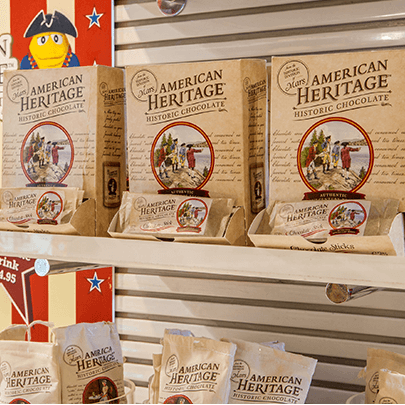 Boxes of American Heritage Chocolate on shelves.